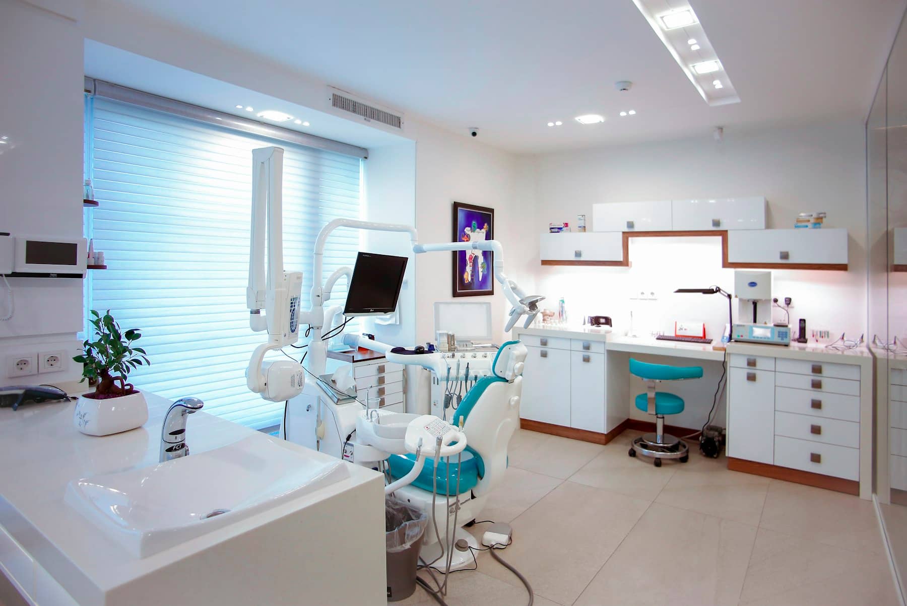 A bright, calm treatment room at Maple & Main Family Dental with a modern dental chair and plants